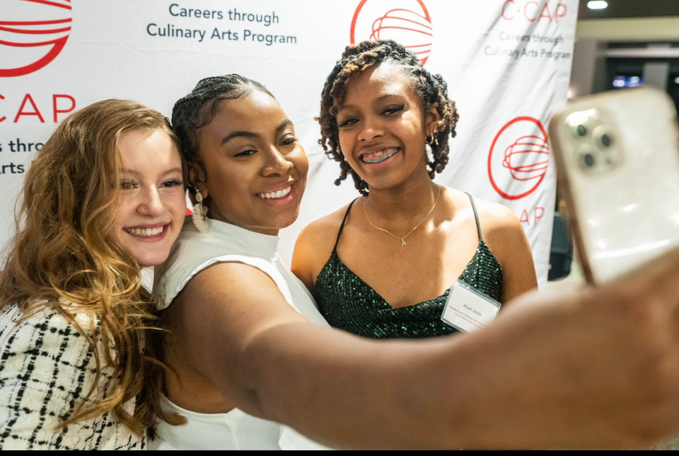 Culinary Student Natalie Mrak taking a selfie at a conference with fellow alum Tonii Hicks 